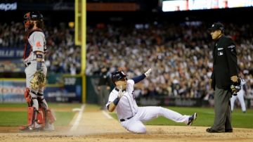 Detroit Tigers' Jose Iglesias scores on a double by Torii Hunter in the second inning during Game 4 of the American League baseball championship series against the Boston Red Sox, Wednesday, Oct. 16, 2013, in Detroit.  (AP Photo/Matt Slocum)