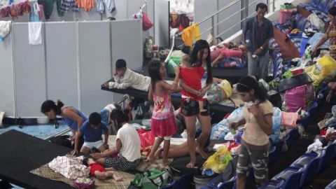 Numerosas personas se refugian en un centro deportivo en Tacloban, en la provincia central de Leyte, Filipinas, donde decenas de miles de supervivientes sufren la carencia de alimentos y agua.