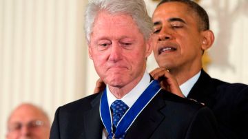 El mandatario Barack Obama coloca la Medalla Presidencial de la Libertad el expresidente Bill Clinton.