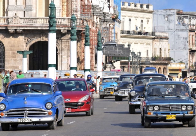 Varios autos circulan por una de las calles centricas de La Habana.