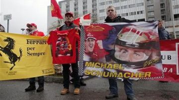 Seguidores de Michael Schumacher sostienen mantas para honrar al siete veces campeón de la Fórmula Uno en su 45 cumpleaños.
