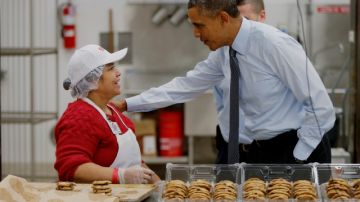 El Presidente saluda a una empleada de la panadería de un Costco en Lanham, Maryland, donde promovió su plan de alza al minímo.