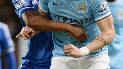 Obi Mikel, del Chelsea (izq.), recibe un jalón de   Negredo