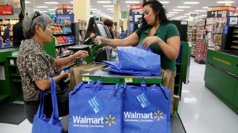 Consumers shop at the new Walmart Neighborhood Market, opening its 34,000 square foot store in the Chinatown district of Los Angeles Thursday, Sept. 19, 2013. (AP Photo/Nick Ut)
