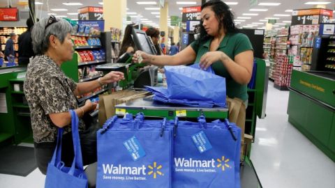 Consumers shop at the new Walmart Neighborhood Market, opening its 34,000 square foot store in the Chinatown district  of Los Angeles Thursday, Sept. 19, 2013. (AP Photo/Nick Ut)