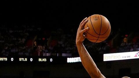 Dwyane Wade pasa por encima de Gerald Henderson.