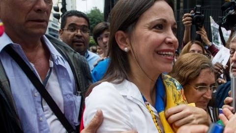 La opositora venezolana Maria Corina Machado (c), a su salida de la sede de la Fiscalía el 16 de junio de 2014, en Caracas.