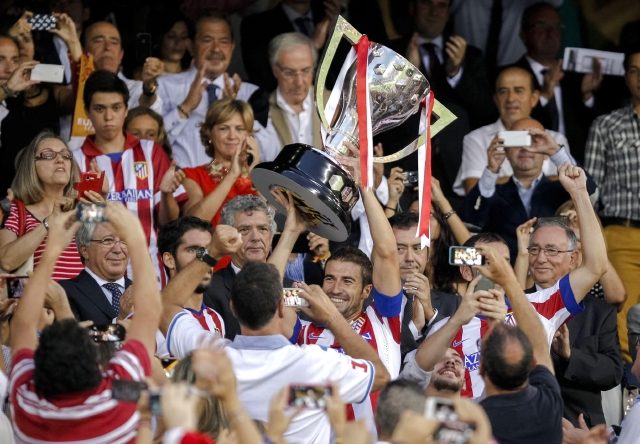 El capitán del Atlético de Madrid, Gabi Fernández, muestra el trofeo de campeón de la liga 2013-2014 antes del partido ante el Eibar en el estadio Vicente Calderón de Madrid.
