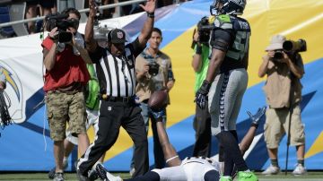 Antonio Gates levanta los brazos después de atrapar uno de sus tres pases de touchdown para el triunfo de San Diego contra Seattle.