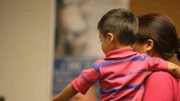 Una madre migrante con su hijo en el Centro Residencial de Artesia, Nuevo México.