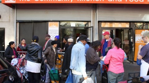 Decenas de personas se acercaron el lunes al Food Bank en la calle 116 para recibir bolsas de alimentos.