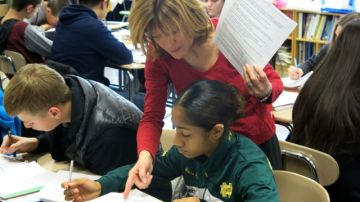 Theresa Dunlap Kutza ayuda a la  estudiante Nicole Blake-Ramsay durante la clase de fisiología y anatomía.