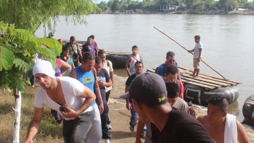 Decenas de migrantes cubanos cruzan este viernes 20 de noviembre de 2015 el río Suchiate, en la frontera de México con Guatemala