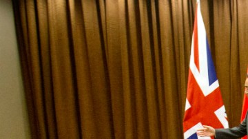 British Foreign Secretary Philip Hammond, right, walks away after shaking hands with Chinese Foreign Minister Wang Yi