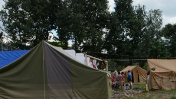 Nepalese earthquake victims collect belongings from a temporary shelter after the Hanumente River overflowed following monsoon rain in Bhaktapur on the outskirts of Kathmandu on August 27, 2015. Monsoon rains are slowing rebuilding and relief efforts after nearly 8,900 people died and some 600,000 homes were reduced to rubble across the impverished Himalayan nation following the deastating earthquake that struck Nepal on April 25. AFP PHOTO / Prakash MATHEMA (Photo credit should read PRAKASH MATHEMA/AFP/Getty Images)
