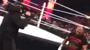 Un aficionado grabó justo el momento cuando el comentarista le entregó algo en la mano a Reigns.