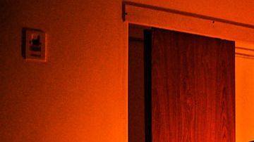 A chambermaid makes a bed at a hotel to