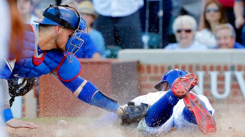 El receptor de los Dodgers, Yasmani Grandal, no puede quedarse con la pelota en la barrida de Jason Heyward, que hizo el 2-0 para los Cachorros.