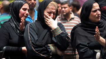 Iraqi women react on July 6, 2016, as people gather at the site of a suicide-bombing attack which took on July 3 in Baghdad's Karrada neighbourhood. The Baghdad bombing claimed by the Islamic State group killed at least 250 people, officials said on July 6, raising the toll of what was already one of the deadliest attacks in Iraq. / AFP / Ahmad al-Rubaye (Photo credit should read AHMAD AL-RUBAYE/AFP/Getty Images)