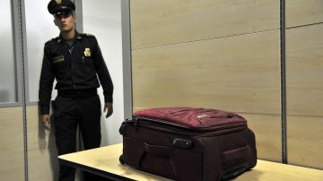 A counter-narcotics police officer looks at a passenger's suitcase in which a double bottom was discovered with two kilos of cocaine at El Dorado international airport in Bogota, Colombia, on September 25, 2015. Trafficking drugs through Bogota's airport is not a happy trip for many who try. AFP PHOTO / GUILLERMO LEGARIA (Photo credit should read GUILLERMO LEGARIA/AFP/Getty Images)