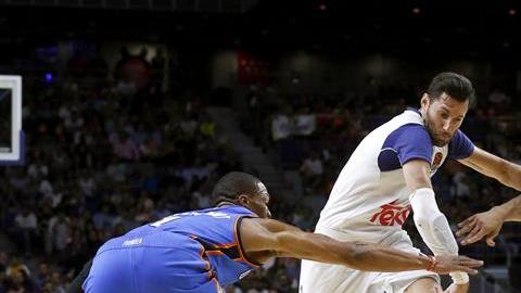 El alero del Real Madrid, Rudi Fernández  intenta superar la defensa de los jugadores del Oklahoma City Thunder, Russell Westbrook y el pivot turco Enes Gulen.