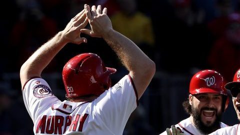 WASHINGTON, DC - OCTOBER 9: Jose Lobaton #59 of the Washington Nationals celebrates with teammates Danny Espinosa #8, Tanner Roark #57, and Daniel Murphy #20 after hitting a three run home run against the Los Angeles Dodgers in the fourth inning during game two of the National League Division Series at Nationals Park on October 9, 2016 in Washington, DC. (Photo by Patrick Smith/Getty Images)