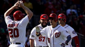 WASHINGTON, DC - OCTOBER 9: Jose Lobaton #59 of the Washington Nationals celebrates with teammates Danny Espinosa #8, Tanner Roark #57, and Daniel Murphy #20 after hitting a three run home run against the Los Angeles Dodgers in the fourth inning during game two of the National League Division Series at Nationals Park on October 9, 2016 in Washington, DC. (Photo by Patrick Smith/Getty Images)
