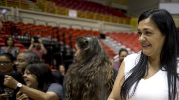 Clarisa sonríe mientras posa con un bizcocho de cumpleaños con la imagen de su papá, el conmutado Oscar López.