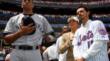 NEW YORK - MAY 21: (L-R) Alex Rodriguez #13 of the New York Yankees stands for the National Anthem with Jennifer Lopez and husband Mark Anthony before the game against the New York Mets on May 21, 2005 at Shea Stadium in the Flushing neighborhood of New York City. The Mets defeated the Yankees 7-1. (Photo by Chris Trotman/Getty Images)
