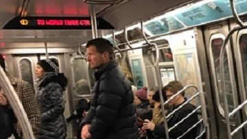 Los vagones del tren E se vacían cuando un desamparado ocupa el servicio.