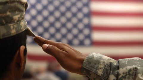 FORT CARSON, CO - JUNE 15: A soldier salutes the flag during a welcome home ceremony for troops arriving from Afghanistan on June 15, 2011 to Fort Carson, Colorado. More than 500 soldiers from the 1st Brigade Combat Team returned home following a year of heavy fighting and high casualties in Afghanistan's southern Kandahar province. (Photo by John Moore/Getty Images)