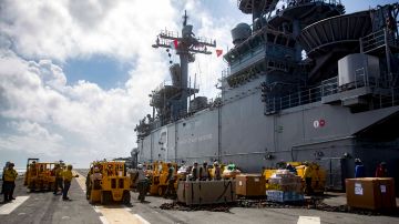 CARIBBEAN SEA - SEPTEMBER 28: In this U.S. Navy handout, sailors aboard the amphibious assault ship USS Kearsarge (LHD 3) move move pallets of supplies on the flight deck during a replenishment-at-sea with the fast combat support ship USNS Supply (T-AOE 6) for continuing operations in Puerto Rico on September 28, 2017. Kearsarge is assisting with relief efforts in the aftermath of Hurricane Maria. The Department of Defense is supporting the Federal Emergency Management Agency, the lead federal agency, in helping those affected by Hurricane Maria to minimize suffering and is one component of the overall whole-of-government response effort.(Photo by Mass Communication Specialist 3rd Class Ryre Arciaga/U.S. Navy via Getty Images)