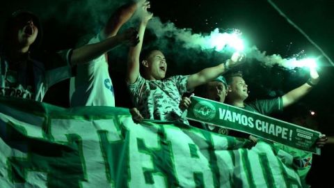 People attend a ceremony in honour of the victims and survivors of Lamia flight 2933 on the first anniversary of the plane crash in Colombia that wiped out Brazilian football club Chapecoense, at the Arena Conda stadium in Chapeco, Santa Catarina, Brazil on November 28 2017. 
The plane was flying Chapecoense to Medellin to take on Atletico Nacional in the Copa Sudamericana finals -- the biggest and most unexpected game in the Brazilian team's history. When the plane ran out of fuel and went down in inhospitable mountains near its destination 71 of the 77 aboard died including 19 players. / AFP PHOTO / NELSON ALMEIDA        (Photo credit should read NELSON ALMEIDA/AFP/Getty Images)