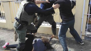 Agentes de la Policía intentan detener a un manifestante.
