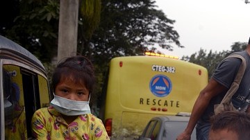 ESCUINTLA, GUATEMALA - JUNE 04: A family are seen as they draw away from effected area by eruption in the community of San Miguel Los Lotes in Escuintla, Guatemala on June 04, 2018. At least 25 people were killed and hundreds others injured when the Fuego Volcano, located 40 kilometers (25 miles) off the capital Guatemala City, erupted on Monday. (Photo by Fabricio Alonzo/Anadolu Agency/Getty Images)