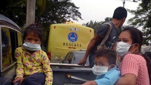 ESCUINTLA, GUATEMALA - JUNE 04: A family are seen as they draw away from effected area by eruption in the community of San Miguel Los Lotes in Escuintla, Guatemala on June 04, 2018. At least 25 people were killed and hundreds others injured when the Fuego Volcano, located 40 kilometers (25 miles) off the capital Guatemala City, erupted on Monday. (Photo by Fabricio Alonzo/Anadolu Agency/Getty Images)