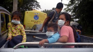 ESCUINTLA, GUATEMALA - JUNE 04: A family are seen as they draw away from effected area by eruption in the community of San Miguel Los Lotes in Escuintla, Guatemala on June 04, 2018. At least 25 people were killed and hundreds others injured when the Fuego Volcano, located 40 kilometers (25 miles) off the capital Guatemala City, erupted on Monday. (Photo by Fabricio Alonzo/Anadolu Agency/Getty Images)