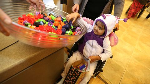 10/31/12----LOS ANGELES---4 year-old patient Julia Duarte collects her treats during the Miller Childrens Hospital Long Beach Halloween event. Dressed up in their Halloween costumes young patients at Miller Childrens Hospital Long Beach trick-or-treat as they visit various departments throughout the hospital halls collecting treats. More than 20 members of the Long Beach Fire Department joined the 50 patients collect healthy treats and small prizes and toys. (Photo by Aurelia Ventura/La Opinion)