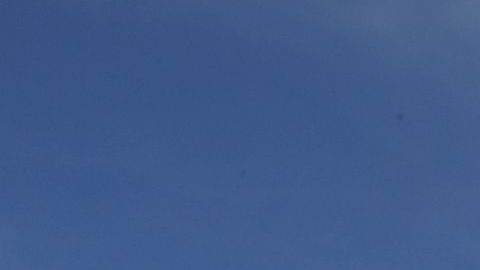 Cristina Bautista y Joaquina García posan con fotos de sus hijos, Benjamín Ascencio Bautista y Martín Getsemaní Sánchez García durante un plantón frente al Consulado de México en Los Ángeles.  (Aurelia Ventura/La Opinion)