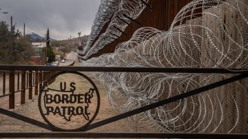 TOPSHOT - A metal fence marked with the US Border Patrol sign prevents people to get close to the barbed/concertina wire covering the US/Mexico border fence, in Nogales, Arizona, on February 9, 2019. (Photo by Ariana Drehsler / AFP)        (Photo credit should read ARIANA DREHSLER/AFP/Getty Images)