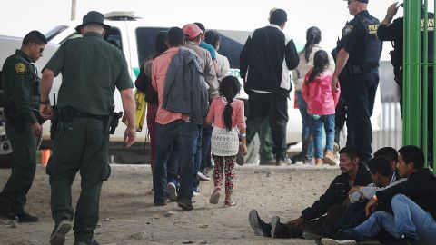 EL PASO, TX - MAY 19: Migrants walk while being detained by U.S. Border Patrol, along with Department of Homeland Security police, after crossing to the U.S. side of the U.S.-Mexico border barrier, on May 19, 2019 in El Paso, Texas. The location is in an area where migrants frequently turn themselves in and ask for asylum after crossing the border.  Approximately 1,000 migrants per day are being released by authorities in the El Paso sector of the U.S.-Mexico border amidst a surge in asylum seekers arriving at the Southern border. (Photo by Mario Tama/Getty Images)