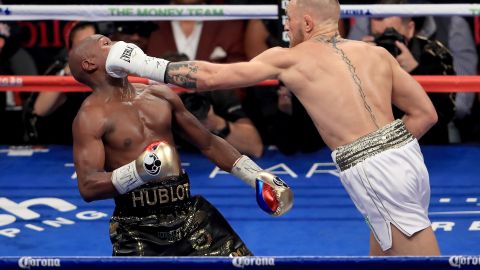 LAS VEGAS, NV - AUGUST 26:  (R-L) Conor McGregor throws a punch at Floyd Mayweather Jr. during their super welterweight boxing match on August 26, 2017 at T-Mobile Arena in Las Vegas, Nevada.  (Photo by Sean M. Haffey/Getty Images)