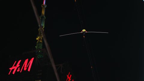 NEW YORK, NEW YORK - JUNE 23: People watch as Nik Wallenda and Lijana Wallenda cross Times Square on a high wire strung between two skyscrapers 25 stories above the pavement on June 23, 2019 in New York City. The two siblings from the famed Flying Wallendas safely crossed the span while thousands watched from below. This was the first professional appearance for Lijana Wallenda since her near-fatal accident in 2017 when she broke nearly every bone in her face. (Photo by Spencer Platt/Getty Images)