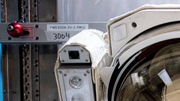 La astronauta de la NASA Christina Koch (d) con la  ingeniera de vuelo de la Expedición 61 Jessica Meir dentro del traje.