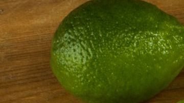 Tequila shots with lime and salt on the wooden background top vi