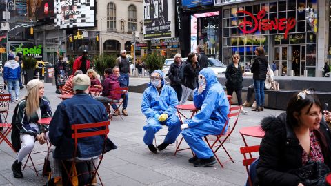 Personas con y sin máscaras en Times Square, 2020.