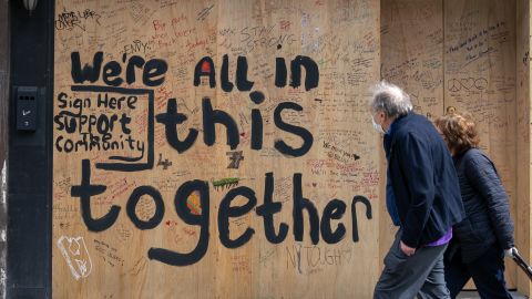 NEW YORK, NY - APRIL 20: A couple walks by a boarded up bar on the Upper East Side on April 20, 2020, in New York City. During his daily coronavirus (COVID-19) briefing, New York Governor Andrew Cuomo said the death toll dropped below 500 in a 24 hour period for the first time since the peak of the pandemic. (Photo by David Dee Delgado/Getty Images)