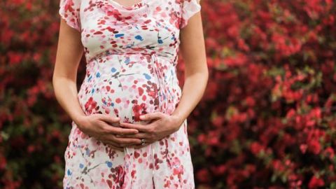 0_Pregnant-Caucasian-woman-holding-her-belly-outdoors