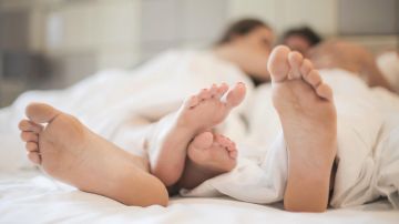 feet-of-couple-in-love-in-bed-3756619
