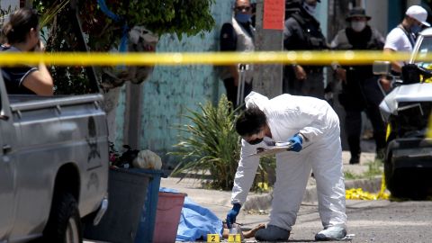 MEXICO-CRIME-VIOLENCE
EDITORS NOTE: Graphic content / A forensic expert works next to a corpse after an armed group attacked two houses killing nine people and leaving one wounded, at the Lopez Portillo neighborhood in Guadalajara, Jalisco state, Mexico on May 3, 2020. (Photo by ULISES RUIZ / AFP) / GRAPHIC CONTENT (Photo by ULISES RUIZ/AFP via Getty Images)